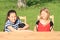 Smiling and grinning girls sitting behind the table