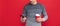 smiling grizzled guy hold phone on red background. hoary man drinking coffee.