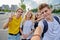 Smiling group of teenagers taking selfie, happy four teens looking at camera