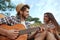 Smiling guy play on guitar to pleased girl