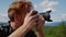 Smiling guy taking photos of picturesque landscape on professional camera