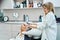 Smiling hairdresser shampooing male hair over hair wash basin