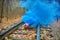 Smiling halloween pumpkin with bright blue smoke on the rails in the forest