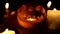 Smiling Halloween pumpkin in candlelight shines at night as mystical lantern