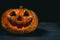 smiling Halloween pumpkin on a dark background