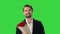 Smiling handsome businessman holding roses and looking to camera flirting on a Green Screen, Chroma Key.