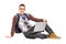 Smiling handsome guy sitting on a floor with laptop and looking