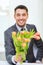 Smiling handsome man giving bouquet of flowers