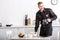 smiling handsome policeman holding glass pot of filtered coffee