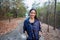 Smiling happy Asian woman is jogging and running on relax time and she wears a fitness watch or sport watch