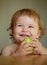 Smiling happy baby with apples. Enjoy eating moment. Healthy food and kid concept. Launching child eat.