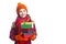 Smiling Happy Caucasian Little Girl In Orange Beanie, Scarf and Mittens With Pile of Colorful Giftboxes. Isolated Against Pure