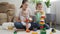 Smiling happy family building high tower with toy blocks and bricks. Concept of family having time together and children