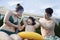 Smiling happy family helping son put on goggles by the poolside