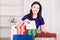 Smiling happy girl prepares bags gifts for Christmas