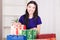 Smiling happy girl prepares bags gifts for Christmas