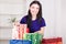 Smiling happy girl prepares bags gifts for Christmas