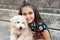 Smiling happy little girl with her pet poodle