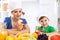 Smiling happy mother and child enjoy and eating fruits