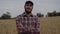 Smiling and happy portrait Caucasian male farmer looking at camera. Young Farm in wheat field.