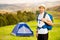 Smiling and happy portrait of young handsome bearded traveller or hiker enjoying activity lifestyle.