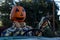 Smiling, happy, welcoming, fun friendly pumpkin head scarecrow driving an old truck to a halloween harvest party