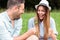 Smiling happy young couple spending time together on a picnic in park