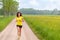 Smiling healthy young woman jogging in nature