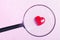 smiling heart on a hightech background and magnifier