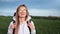 Smiling hiker girl in glasses walking on field with backpack. Medium close up shot on 4k RED camera