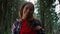 Smiling hiker looking at camera in fairytale forest. Woman posing at camera