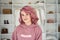 Smiling hipster gen z teen girl fashion designer pink hair headshot portrait.