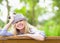 Smiling hipster girl sitting on bench in the park