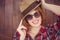 smiling hipster woman wearing a trilby and sunglasses