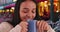 Smiling Hispanic girl enjoys a cup of coffee at a cafe in Bruges.