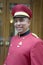 Smiling hotel bellman with red jacket on, in Rome, Italy, Europe