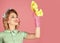 Smiling housewife dressed in retro style. Happy Housekeeper. Retro woman cleaner on pink background. Cleanup, cleaning