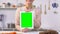 Smiling housewife holding tablet with green screen, products delivery app