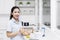 Smiling housewife stirring apple in bowl