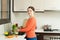 Smiling housewife washing vegetables