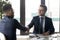Smiling hr manager shaking hand of successful candidate after interview