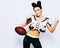 Smiling incredibly beautiful, athletic brunette girl in a shoulderpads and an American football helmet demonstrating