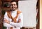 Smiling Indian Teacher Guy Posing Near Blackboard Standing At Home