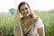 Smiling Indian woman farm owner standing in agricultural field