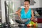 Smiling Indonesian woman making food in wok