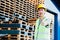 Smiling industrial logistics worker with hard helmet in facilities with thumbs up