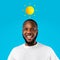 Smiling inspired millennial african american guy with abstract sun above head