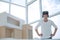 Smiling interior designer standing in front of his Desk