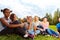 Smiling international friends sitting on grass