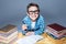 Smiling kid in glasses doing homework at the desk